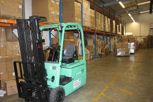 Forklift in goods in warehouse